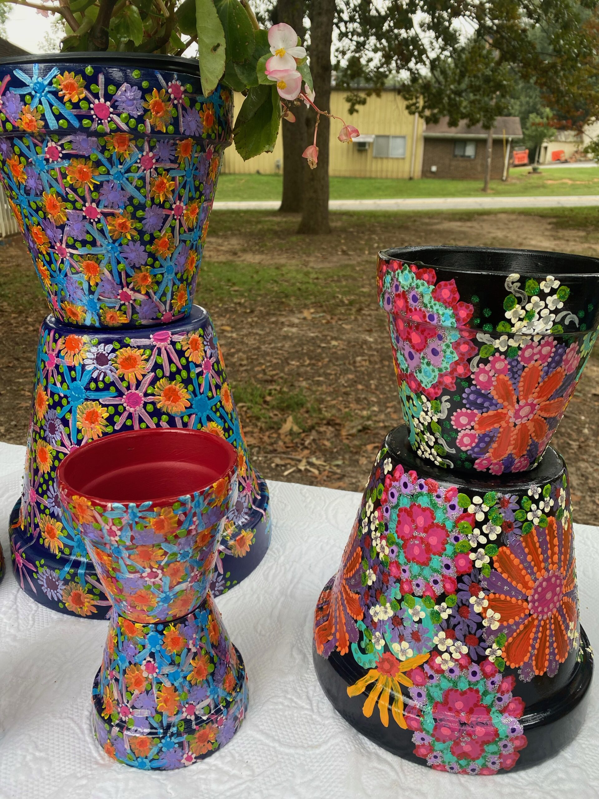 Colorfully painted with flowers terracotta pots on display at a local farmer's market